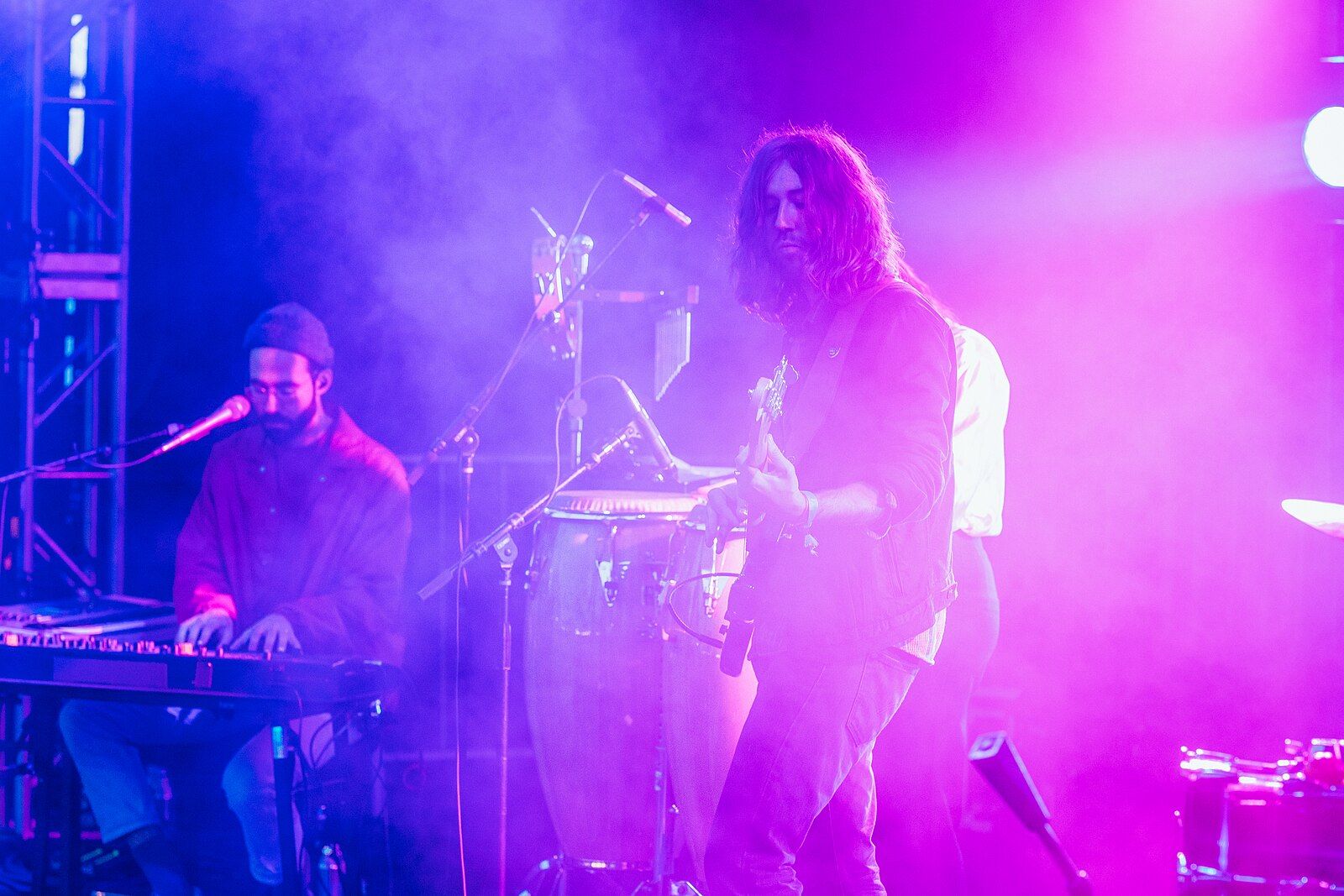 A band performing under colored stage lights at Treefort Music Fest